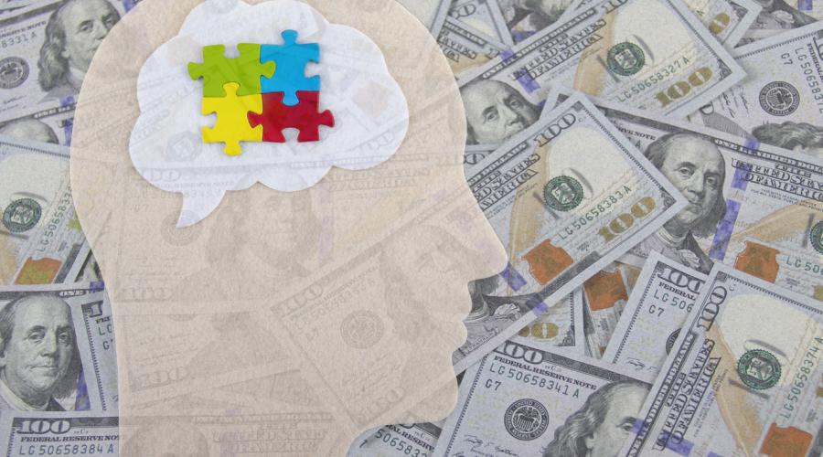 The symbolic image of autism puzzle pieces superimposed by $100 bills.