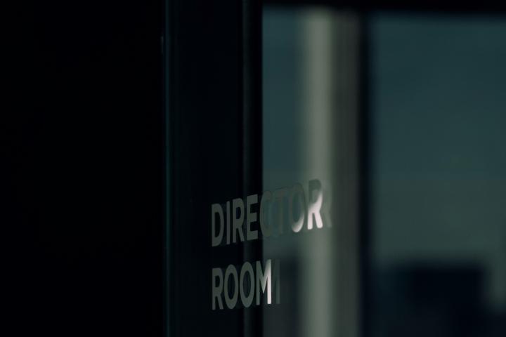 glass partition with words 'director room' showing light effects