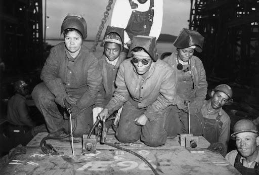 Black and white photo of several female industrial workers