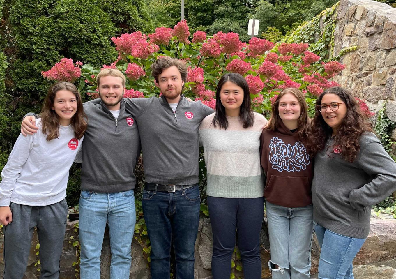 Six Cornell students pose together outside
