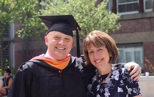 Susan Beauregard, executive director of ILR's EMHRM degree program, congratulated Derek Cullimore at his graduation ceremony.