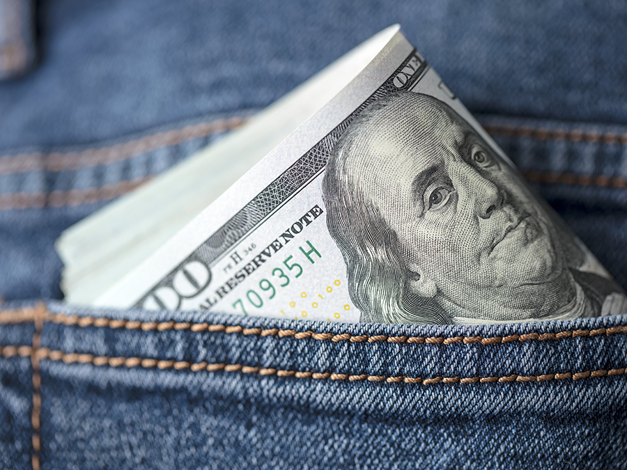 Money in the back pocket of a pair of jeans