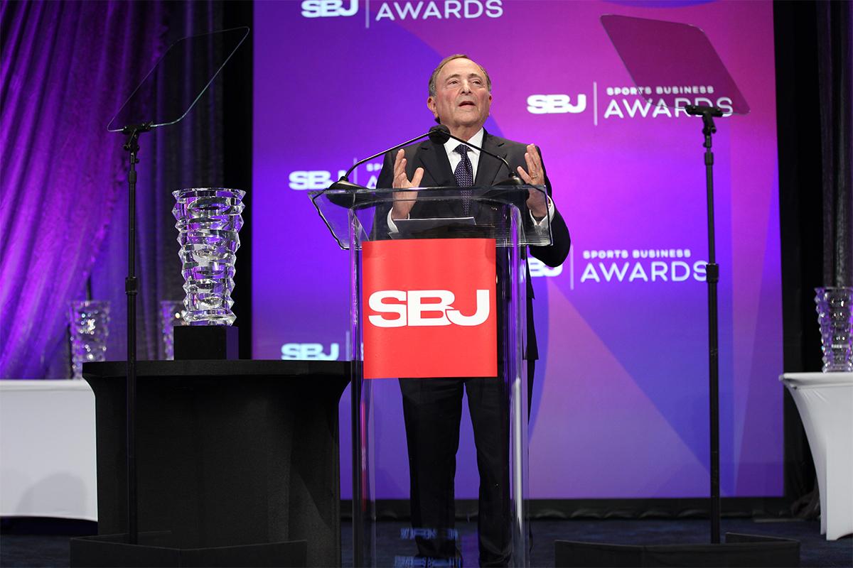 Gary Bettman speaking at a lectern at the Sports Business Awards.