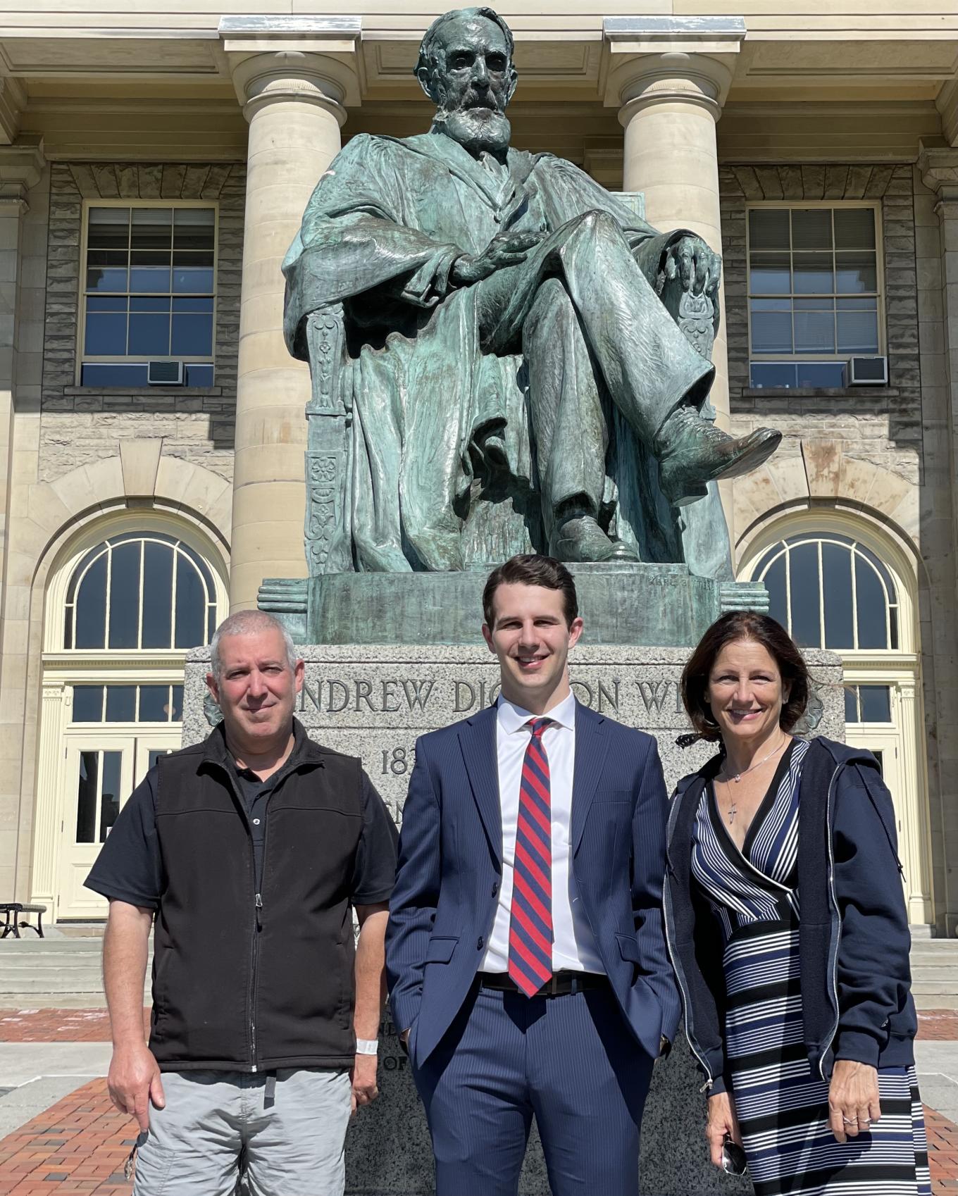 Stu Speckman '86, Drew Speckman '20 and Alicia Kennedy in front of the Ezra Cornell statue on Cornell's Ithaca campus