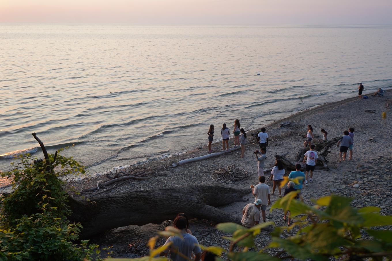 Buffalo High Road students at the beach, walking along the shore
