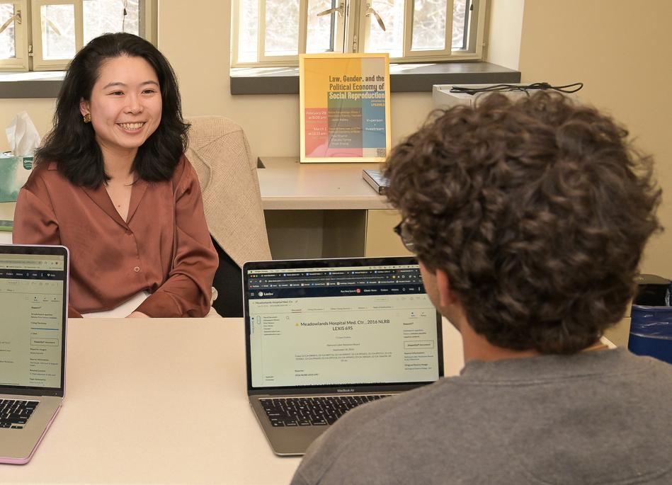Yiran Zhang speaks with a student in her office in the spring of 2024.