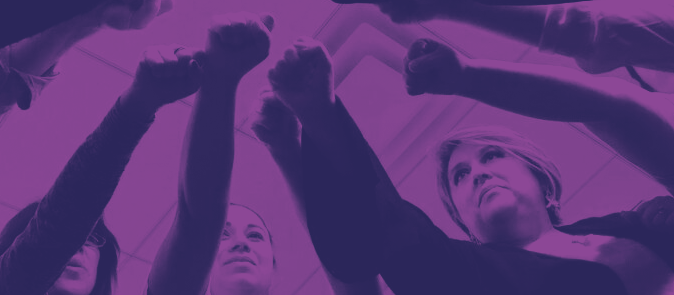 dark shadow image of workers reaching into a circle with fisted hands