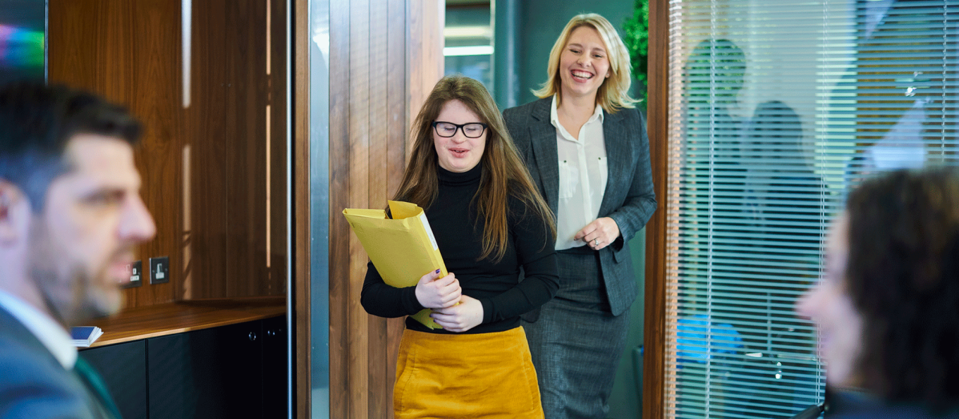 two business women walking into a conference room