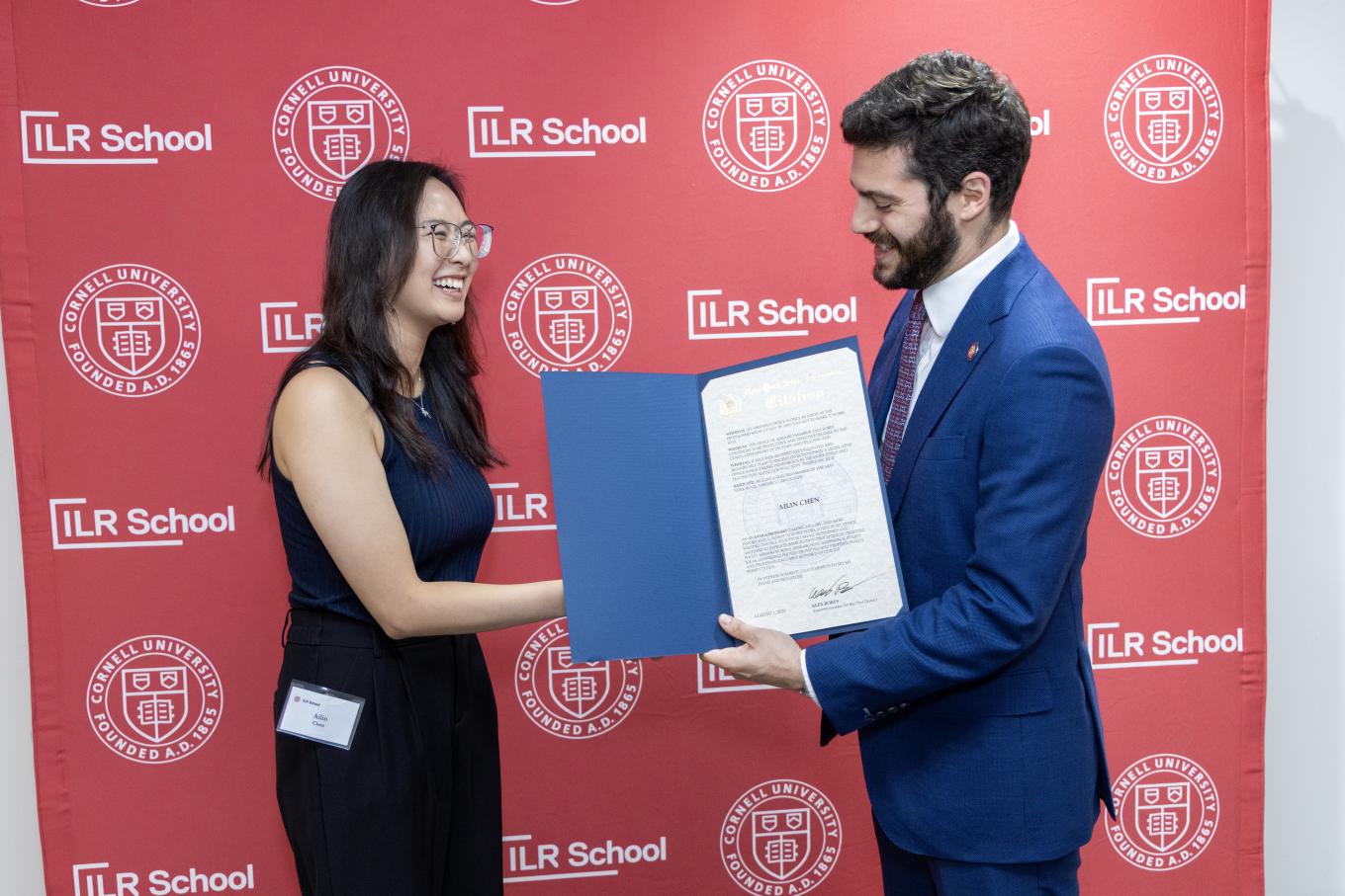 NYS Representative Alex Bores handing student certificate for her contribution this summer