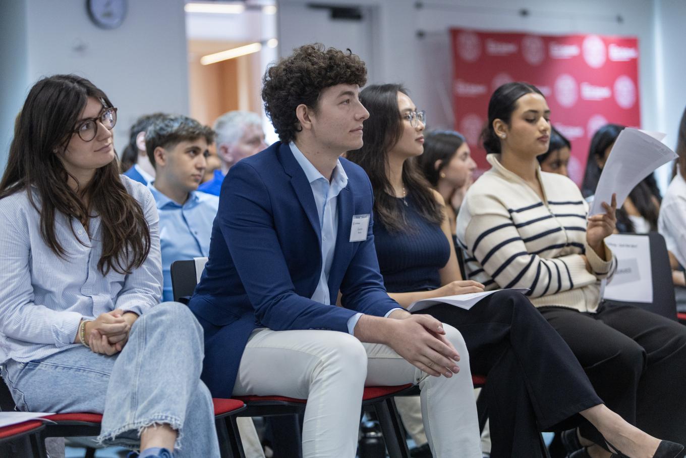 Mixed group of High Road scholars watching presentations