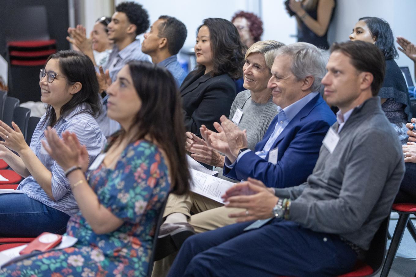 Mixed group smiling and clapping