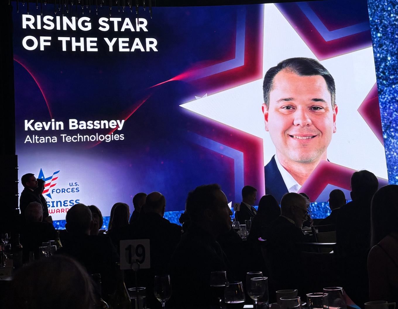 A video screen featuring Kevin Bassney '13. 