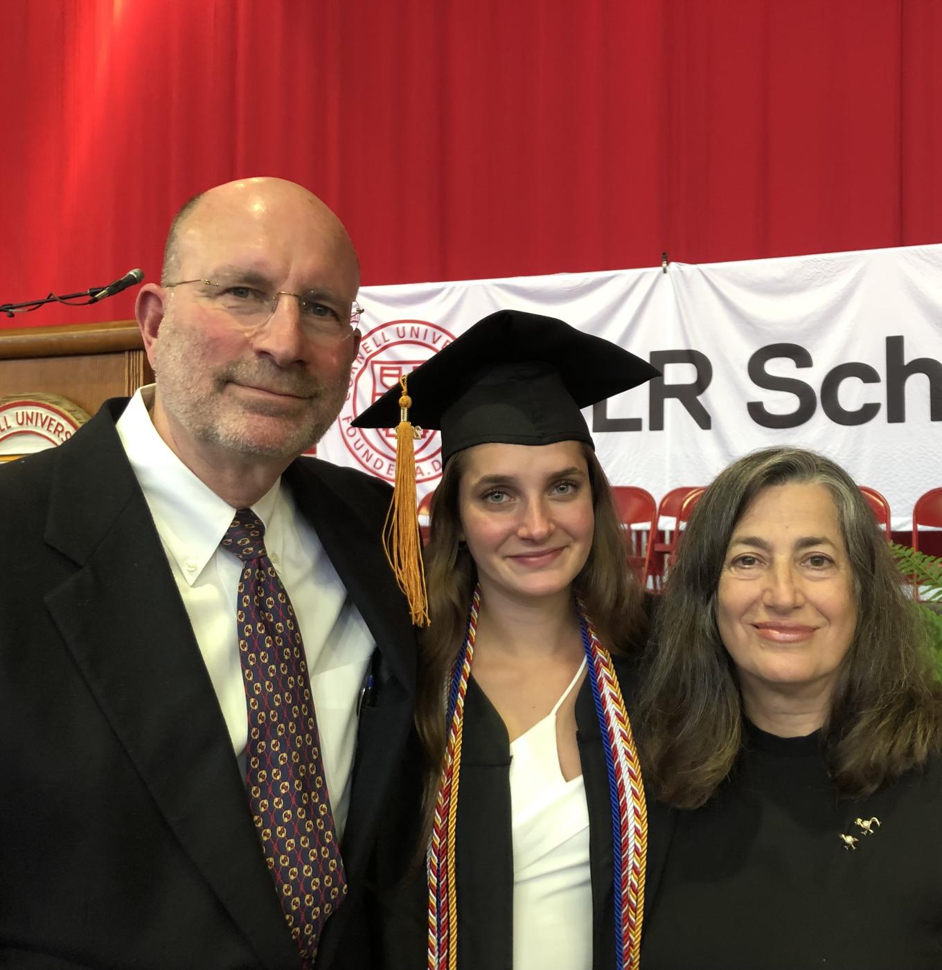 Ken Kirschner ’75 and Andrea Chase '79 pose with their daughter, Samantha Kirschner '22, on her graduation day. 