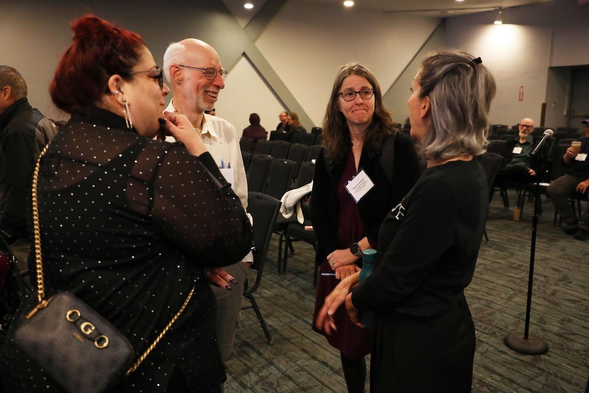 Four DREAM attendees standing and chatting