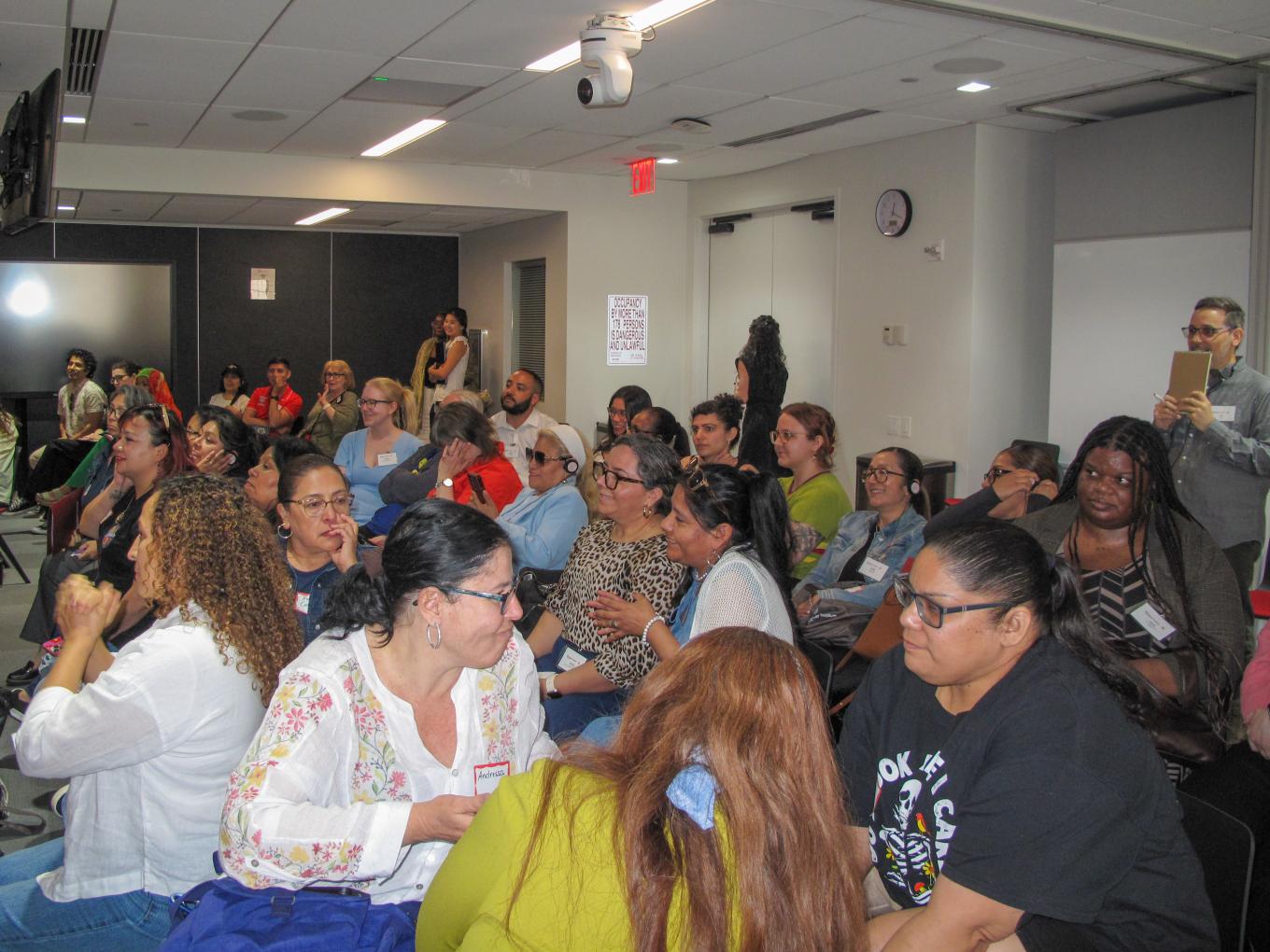 Mixed group audience speaking to one another