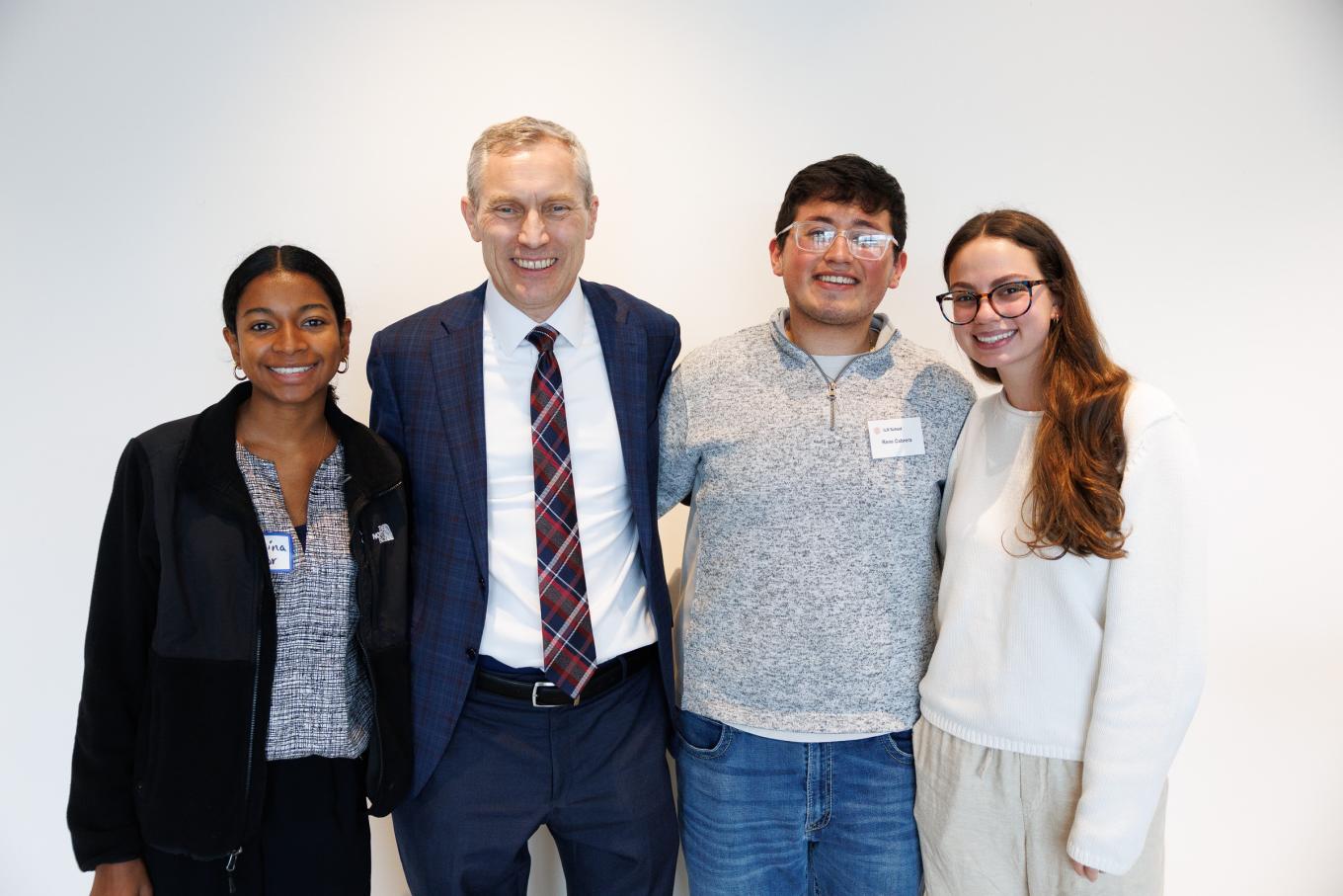 Dean Alex Colvin with three students