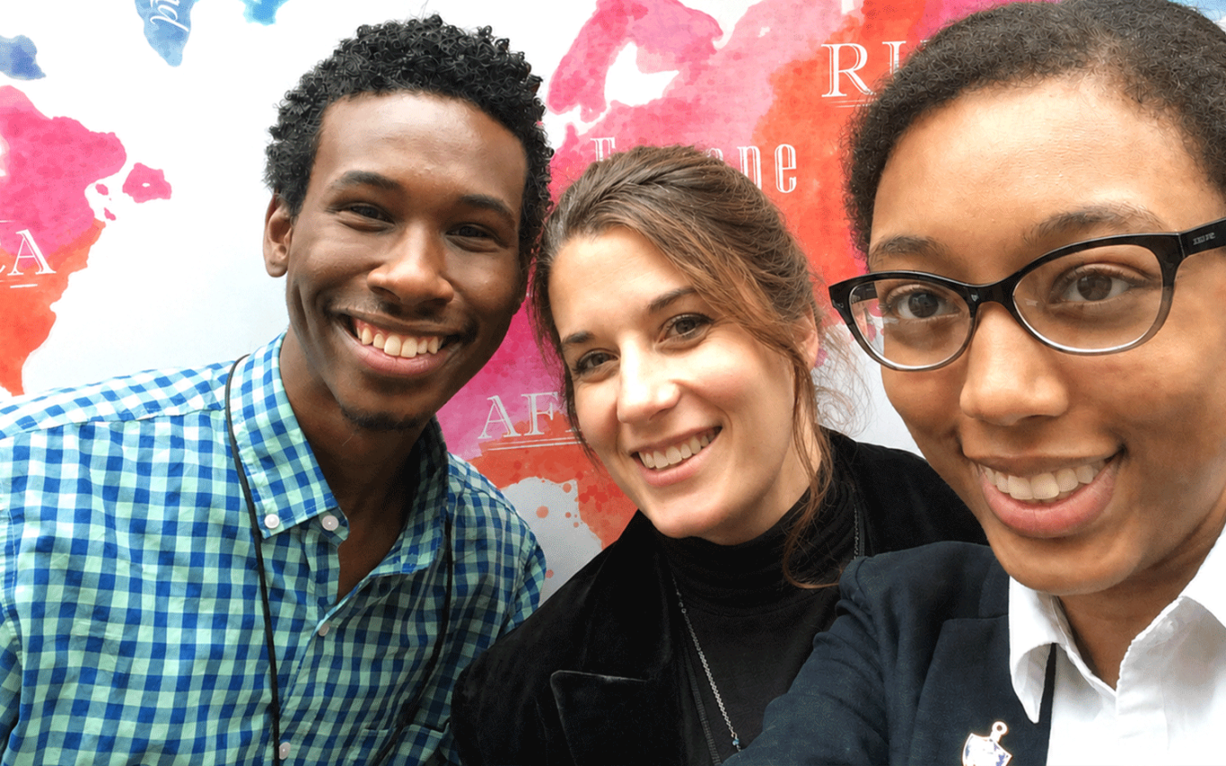 Brigid Beachler standing between two students