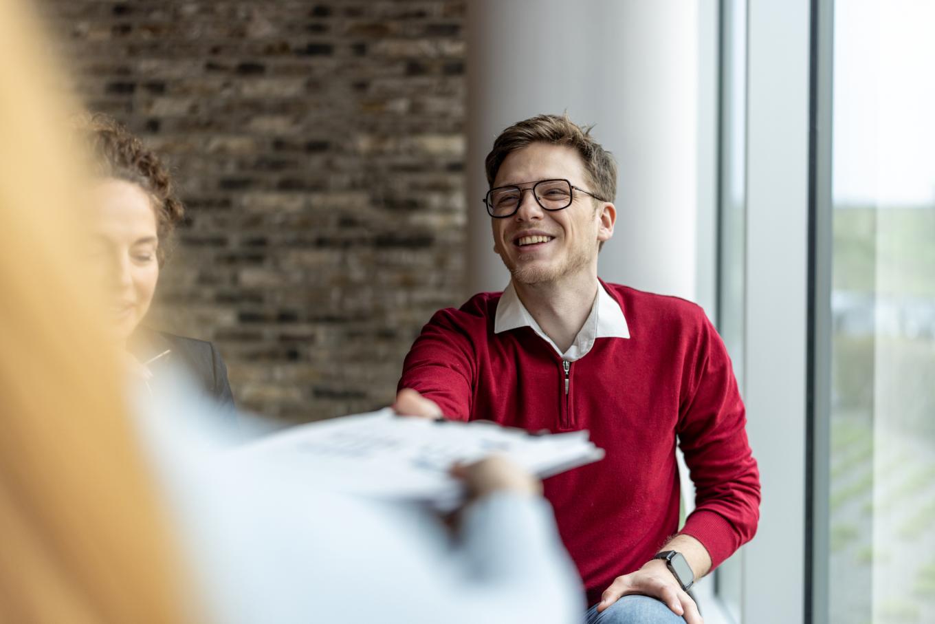 Getty stock image of HR person in meeting wearing red sweater