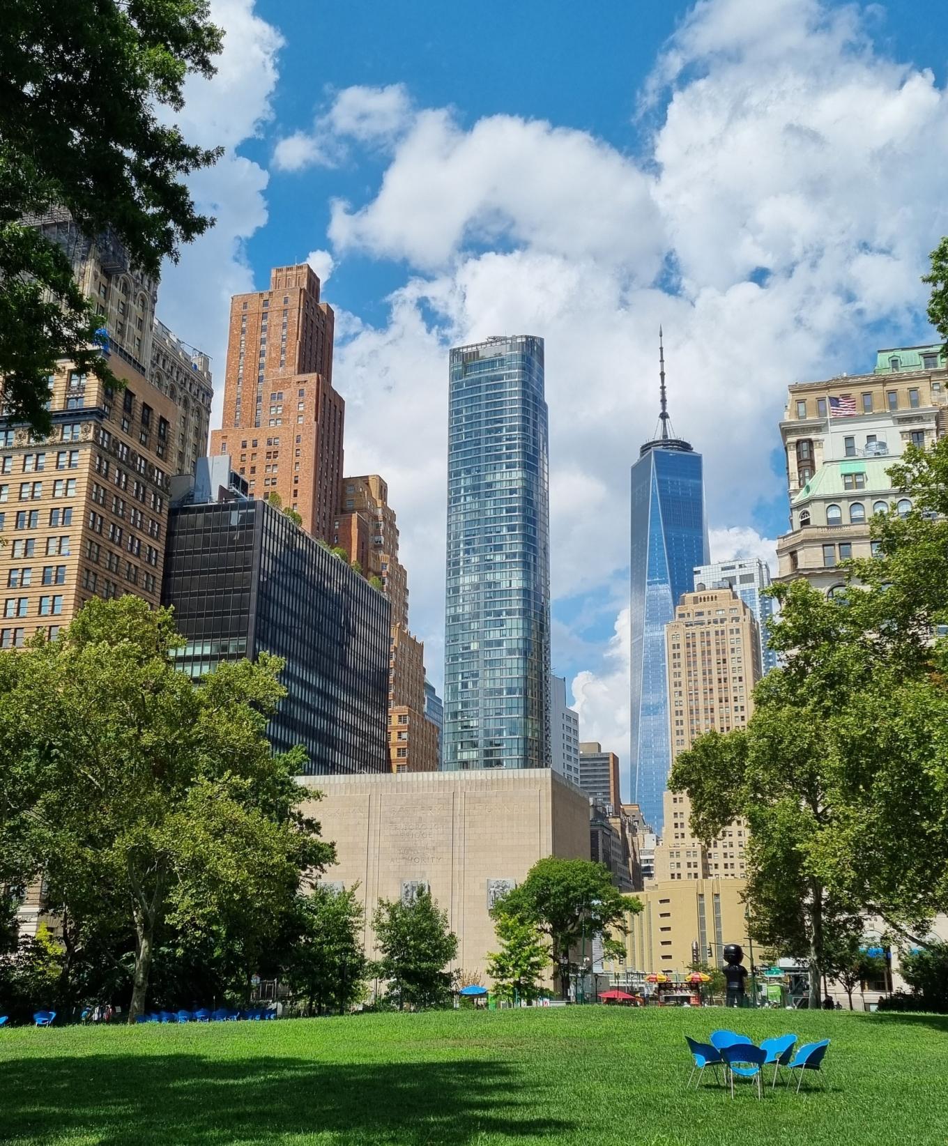 Green lawn in park with the nyc high rise buildings in the skyline behind it