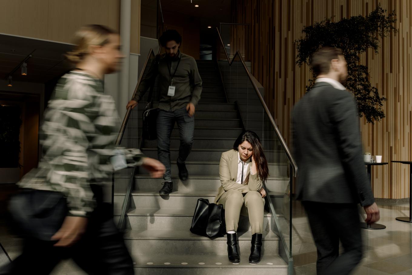 Frustrated businesswoman sitting on staircase