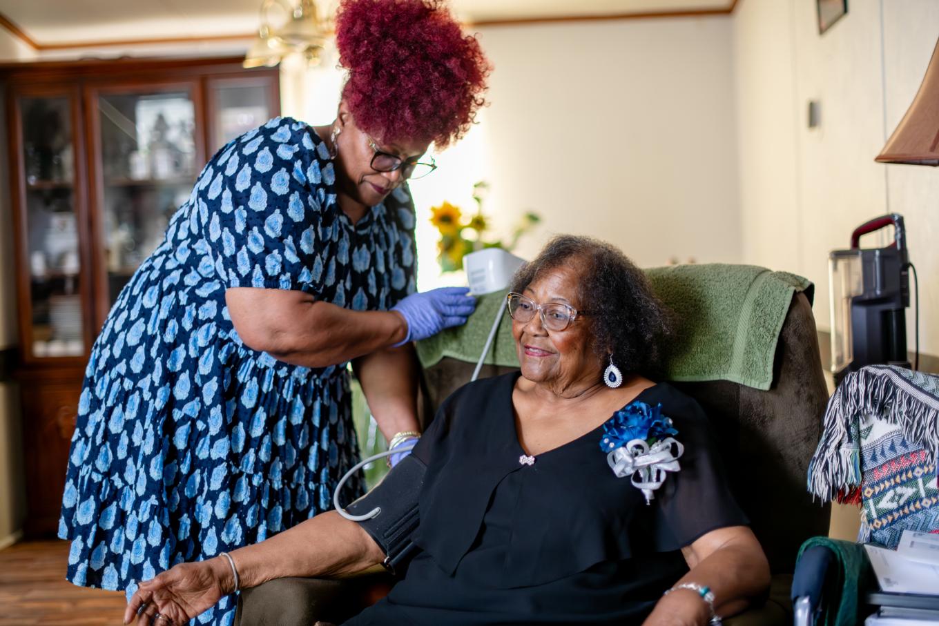 Senior getting blood pressure checked at home