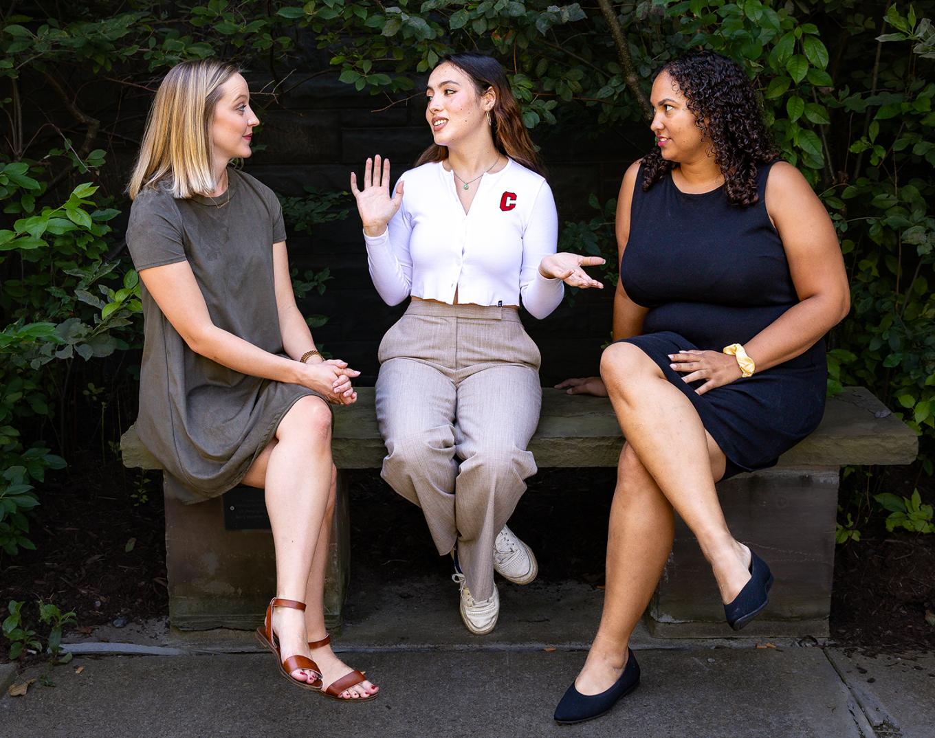 MILR students sitting on a bench chatting