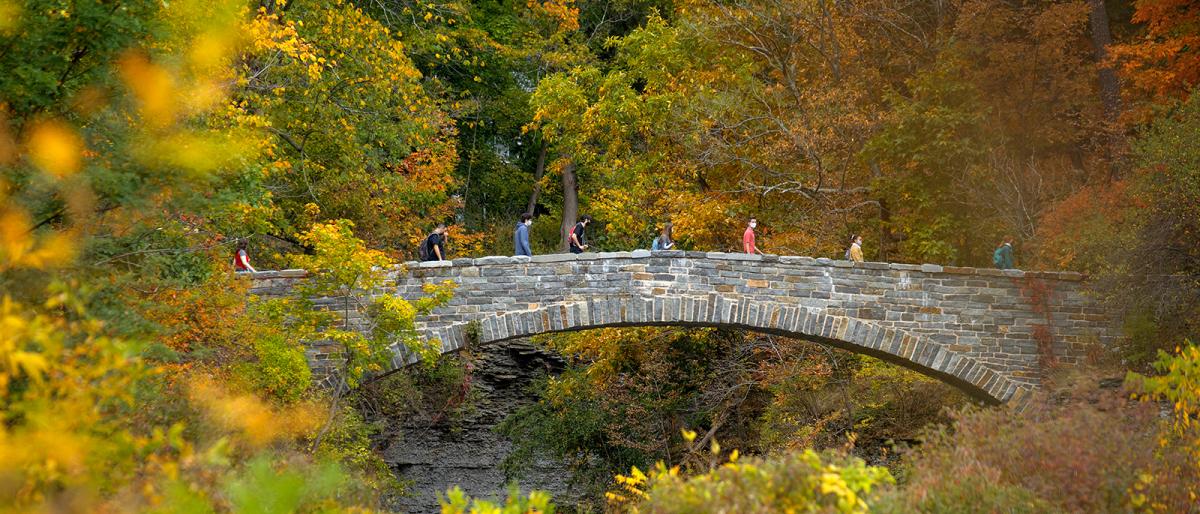 Students cross the foot bridge over Beebe Lake during an afternoon class walk.