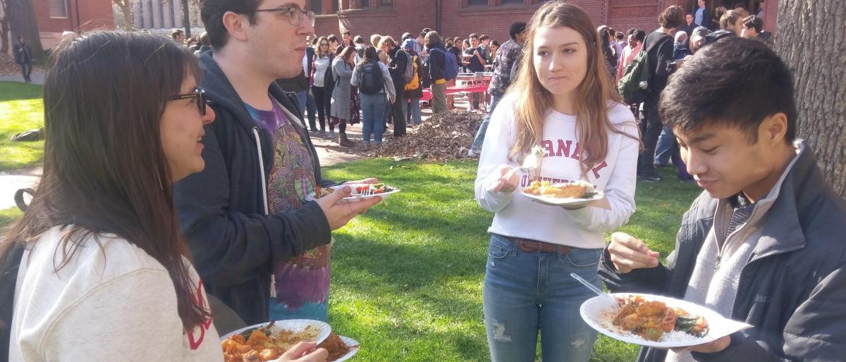 Policy debaters eating lunch during the fall in the courtyard during the Harvard tournament