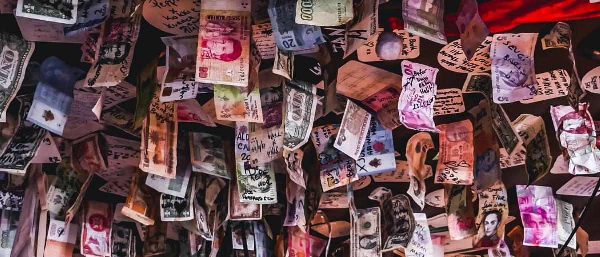 :paper money of different currencies hung from a ceiling, Jonny McKenna