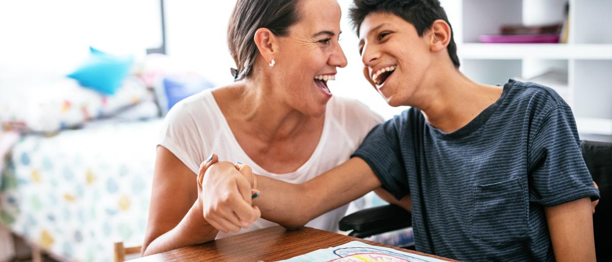 Mother and son with a disability enjoying time together at a table