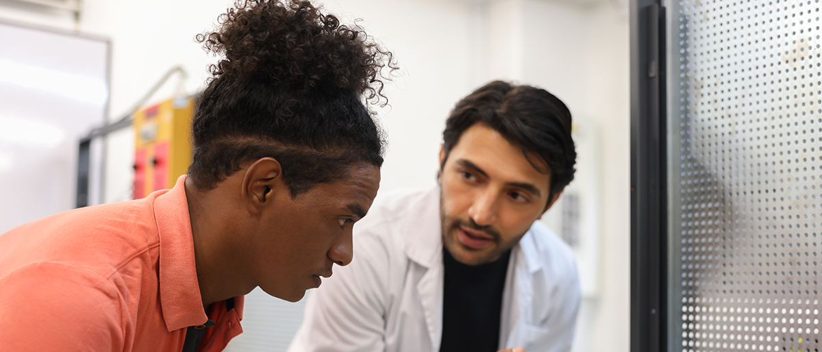 A professor speaks with a student.