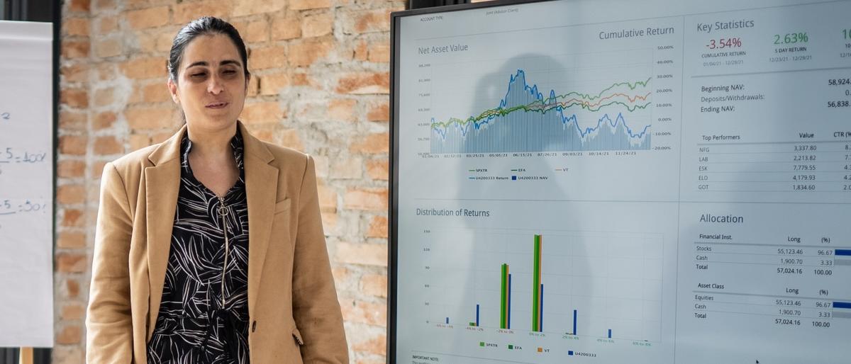 An officeworker gives a presentation and is accompanied by a service dog