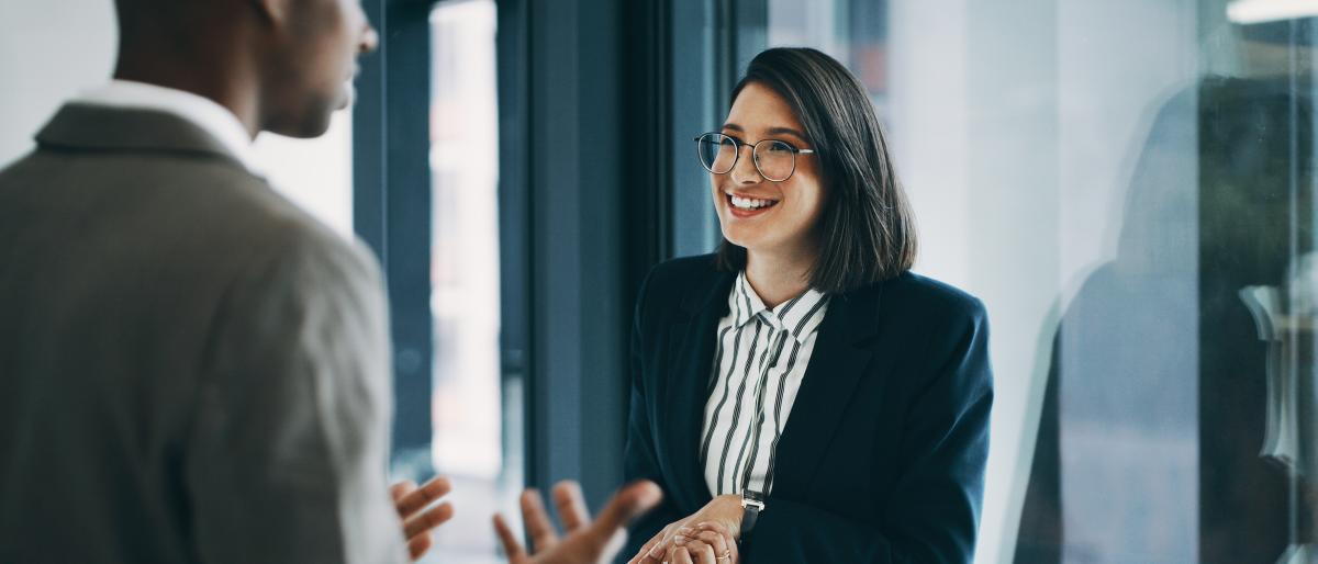Woman shaking hands with man in a meeting