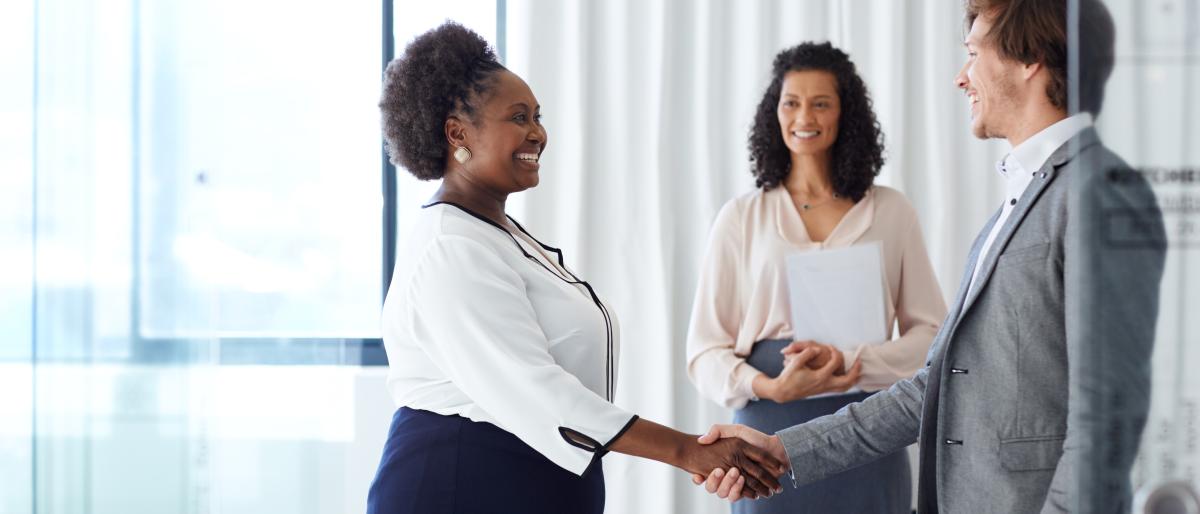 Shaking hands during a business meeting.