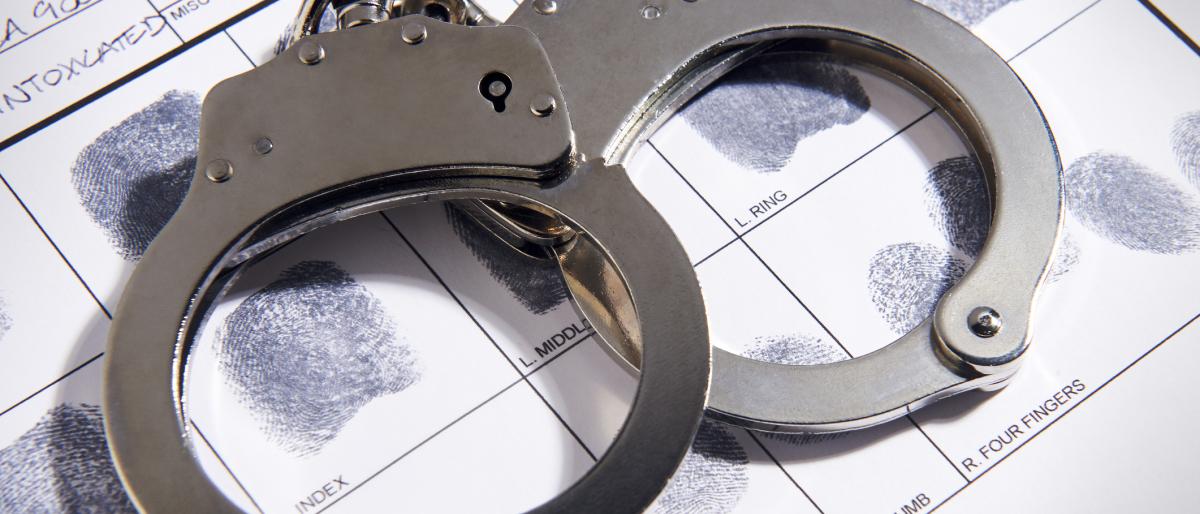 Handcuffs laying on top of fingerprint chart in file