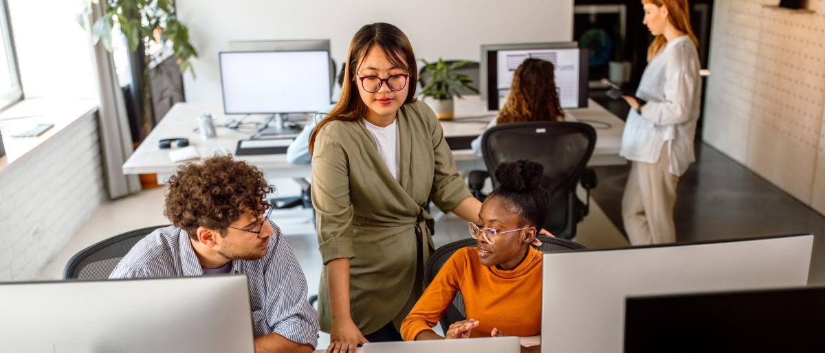 Office workers in an open plan desk area