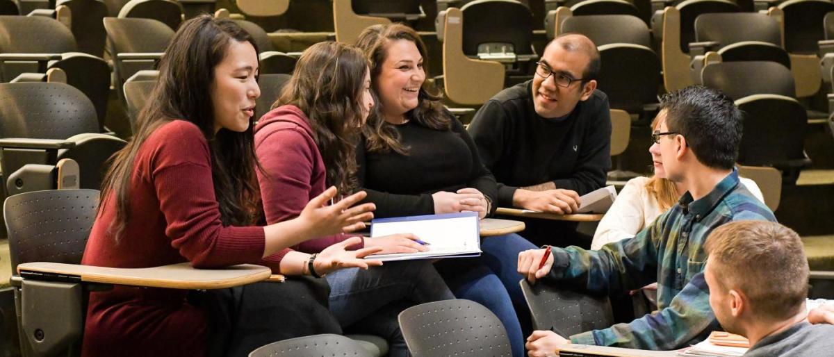 students talking in a circle at desks