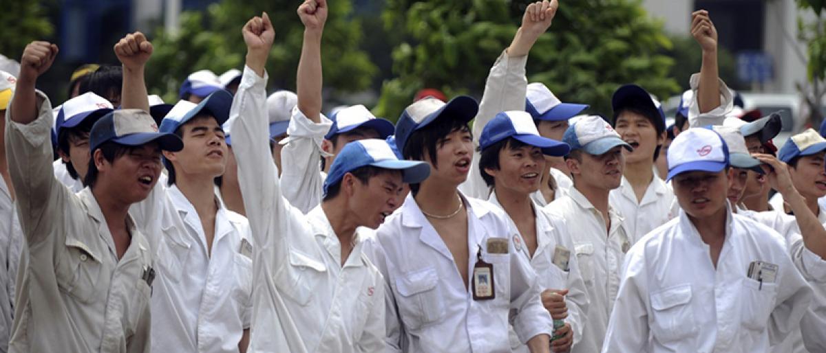 Chinese workers dressed in white at public demonstration