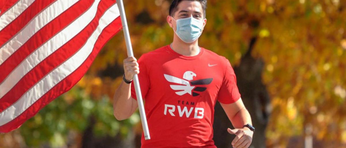 Michael Sanchez, a veteran of the United States Marines and ILR student, carries an American flag while on a weekly run with Team Red, White and Blue, a nonprofit veterans organization.