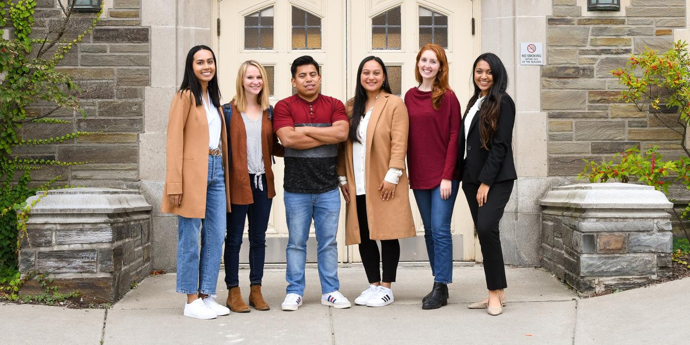 six MILR students standing in front of ILR's Ives Hall