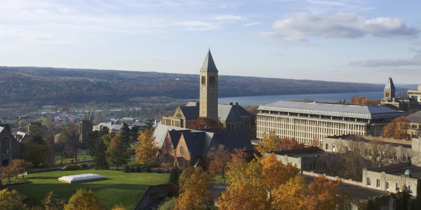 Clock tower on campus with Cayuga Lake behind it