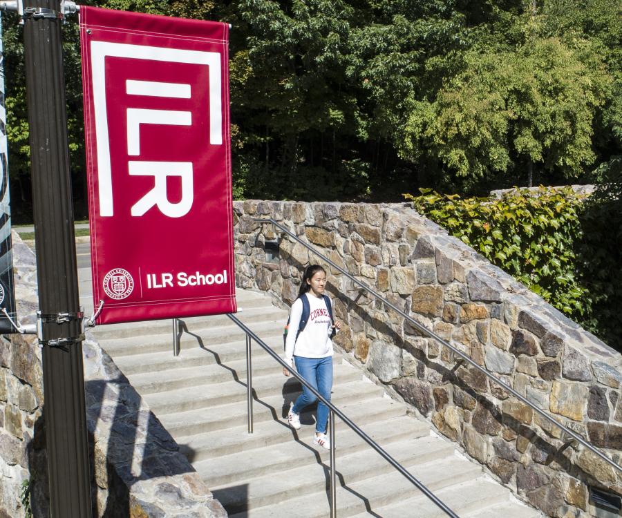 A student walking down the steps outside Ives Hall