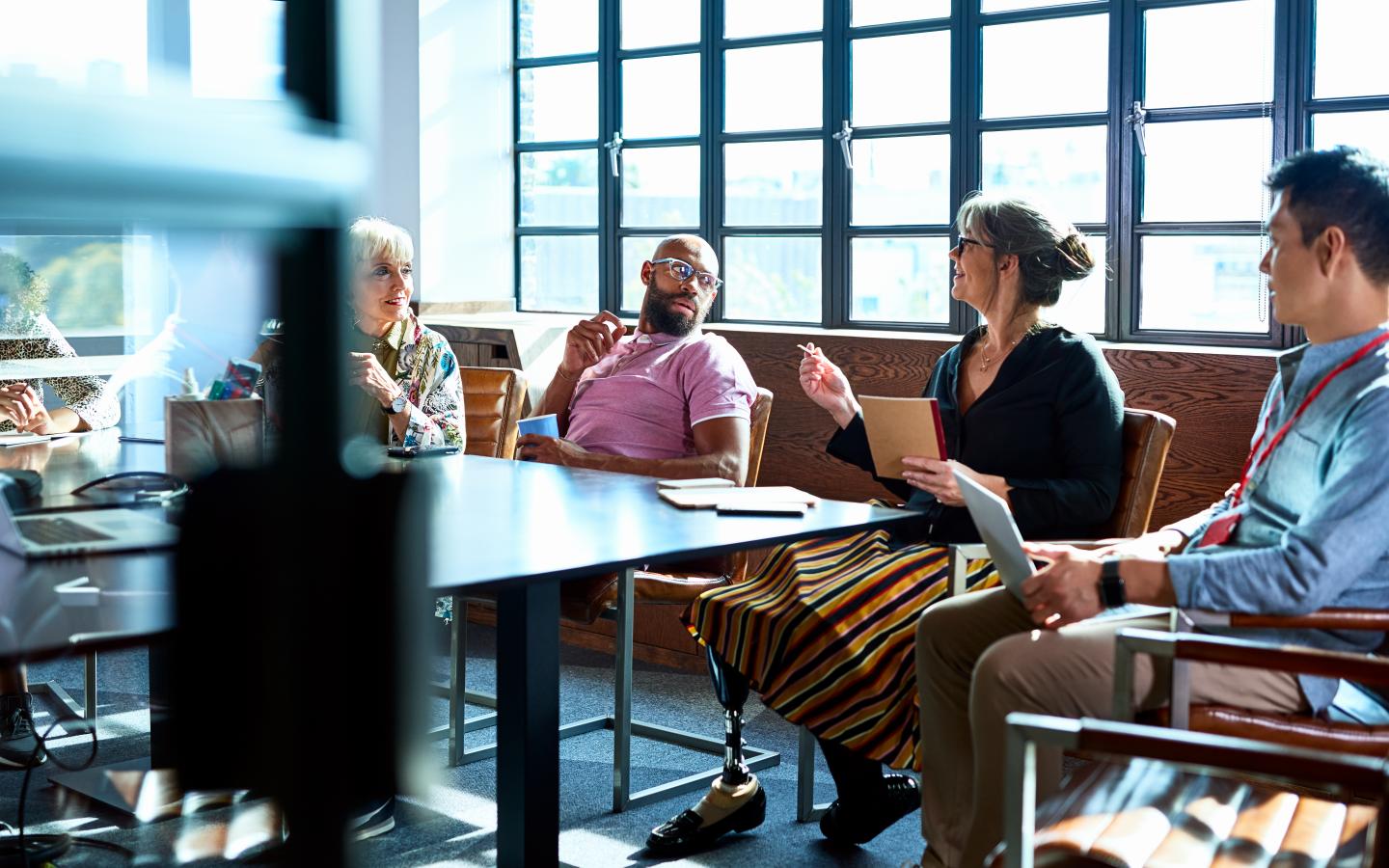 coworkers meeting around a conference table