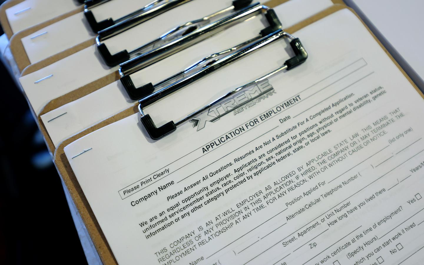 A blank job application form on a clipboard.