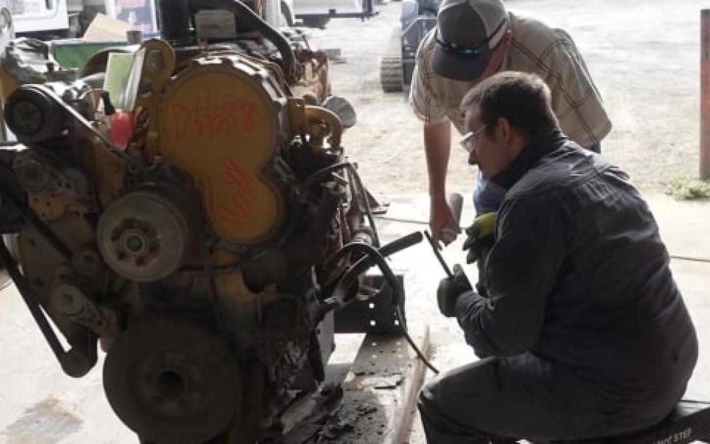 An ICAP participant learning about engine repair