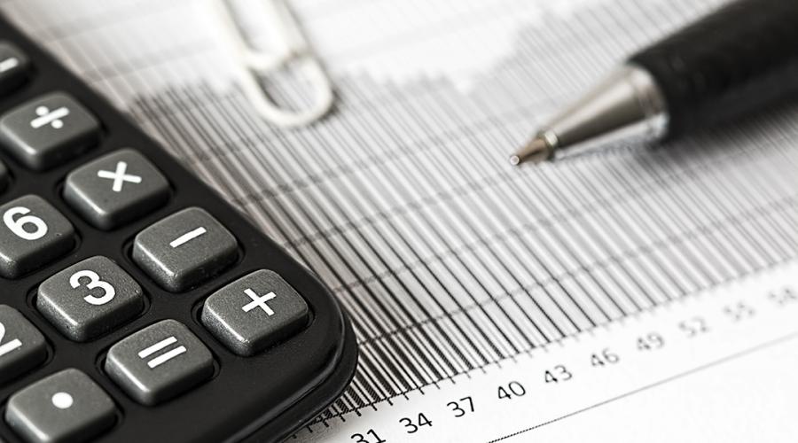 photo of a calculator and pen to illustrate taxes