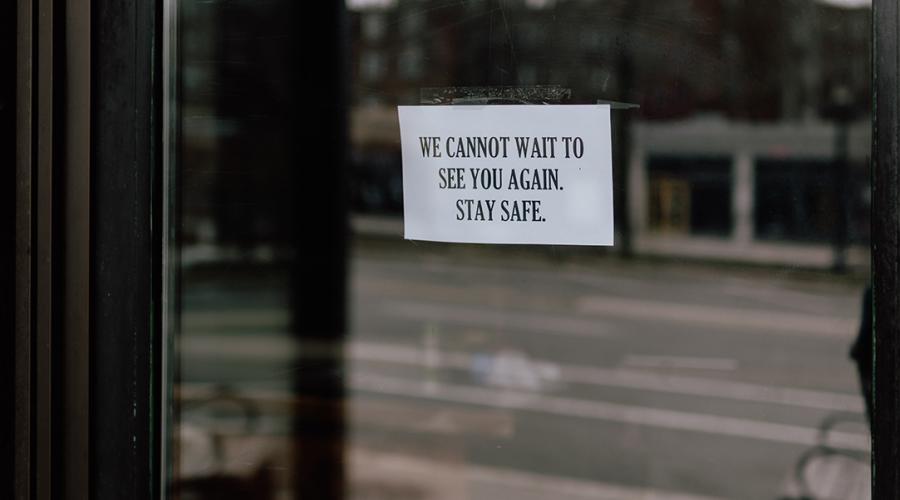 photo of a shop door with a note saying:"We cannot wait to see you again, stay safe."