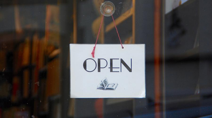 sign in a window saying: "open"