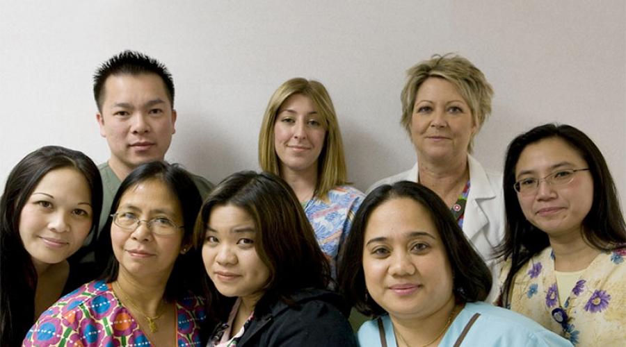 Eight healthcare workers pose for a group portrait