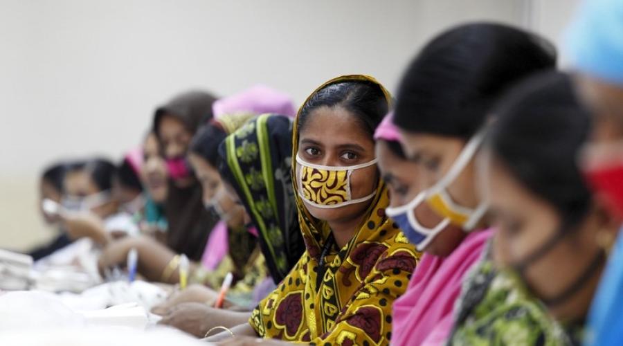 Female garment workers wearing masks.